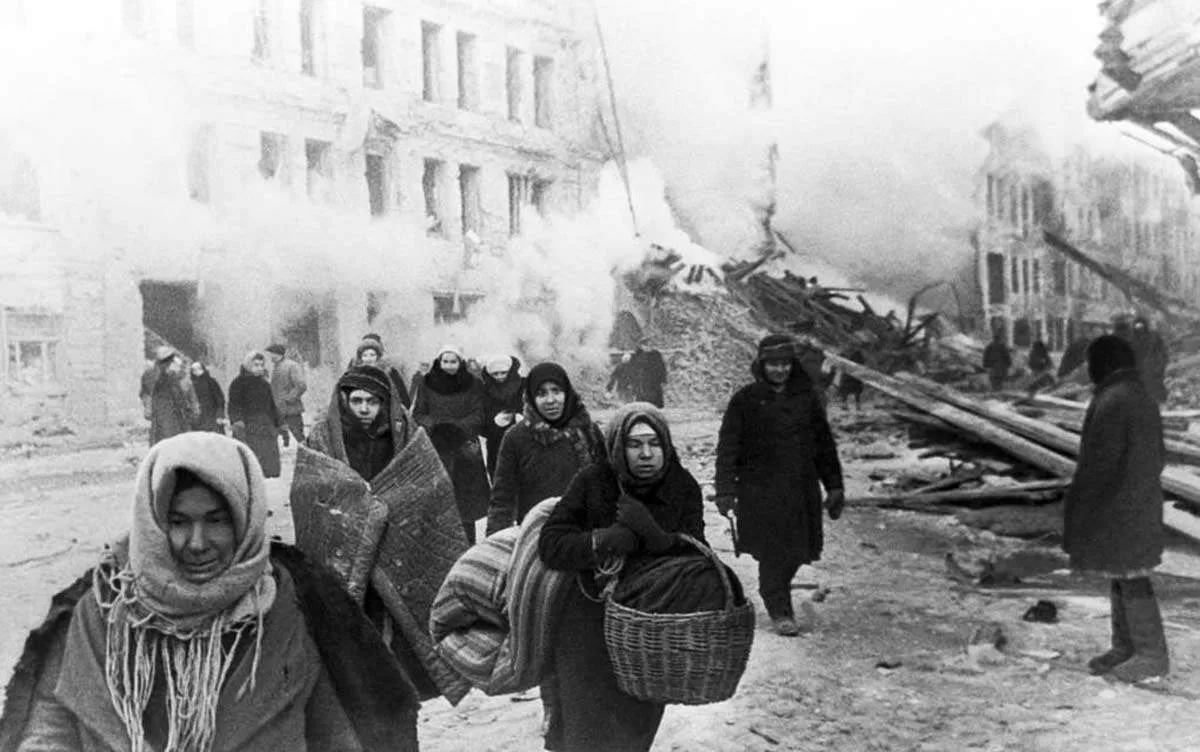 residents-leaving-destroyed-building.jpg