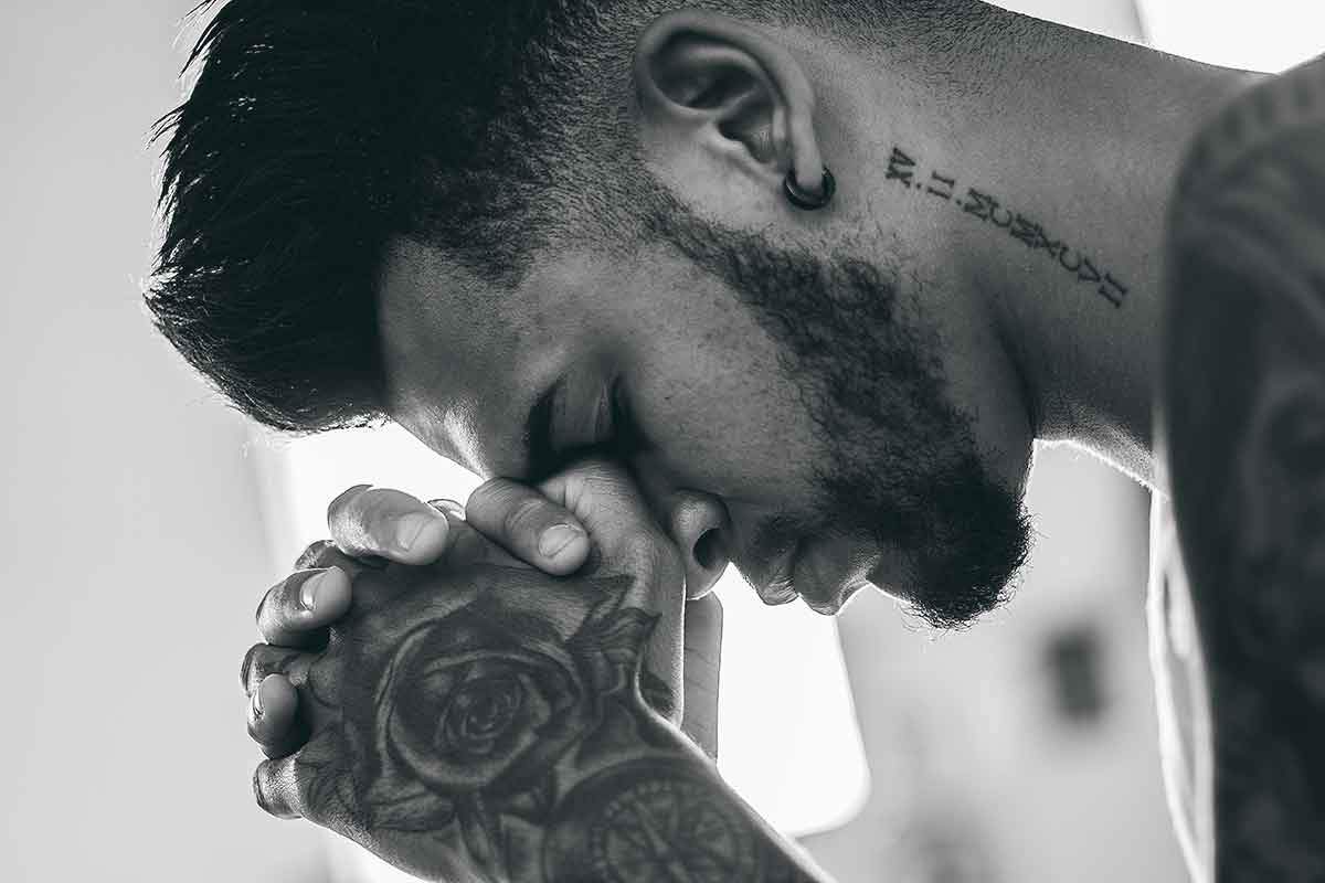 tattooed-man-praying.jpg